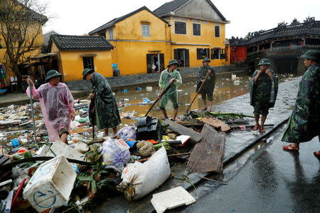 Vietnam soldiers clean debris caused by flooding by Typhoon Damrey in the ancient UNESCO heritage town of Hoi An, Vietnam November 8, 2017. REUTERS/Jorge Silva