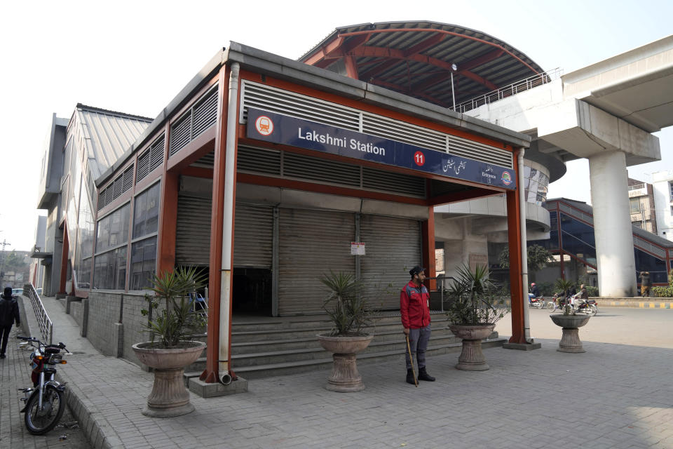 A worker of the Orange Line metro train stands at a station which is closed following a power breakdown across the country, in Lahore, Pakistan, Monday, Jan. 23, 2023. Much of Pakistan was left without power for several hours on Monday morning as an energy-saving measure by the government backfired. The outage spread panic and raised questions about the cash-strapped government’s handling of the crisis. (AP Photo/K.M. Chaudary)