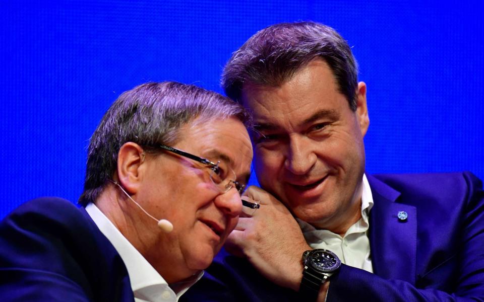 Armin Laschet (L) and his rival, leader of the conservative Christian Social Union (CSU) party Markus Soeder - TOBIAS SCHWARZ /AFP