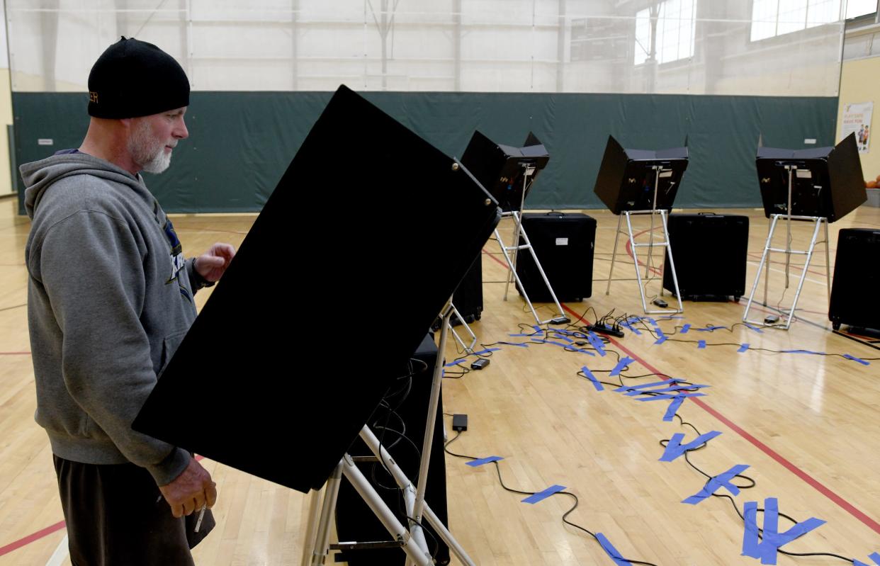 Steve Reese casts a vote Tuesday at the Towpath Trail YMCA polling station in Navarre. Officials say Stark County's new Dominion voting machines performed well.