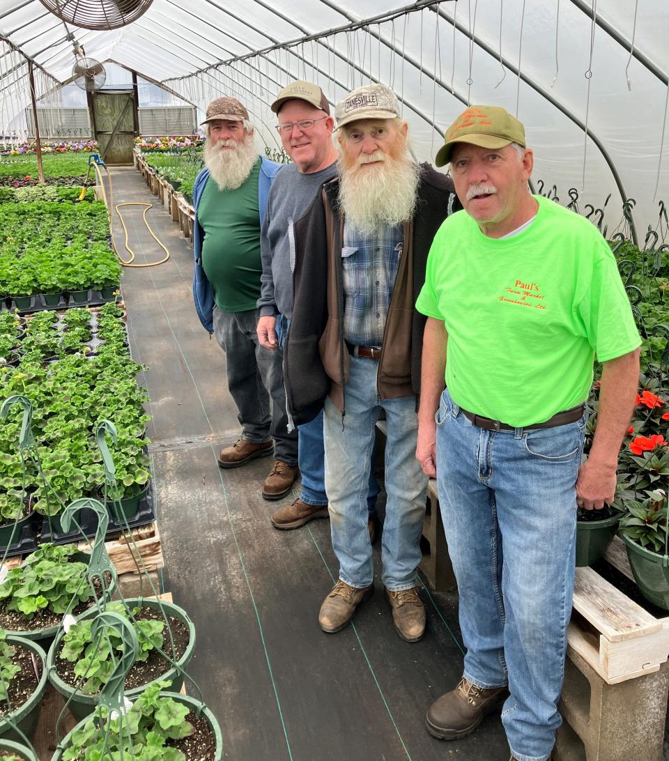 The Paul brothers, Marvin, left, Myron, Terry and Teddy stand in on the greenhouses at Paul's Farm Market in Zanesville. The family-owned business, which sells a variety of plants and vegetables, will celebrate its 75th anniversary this year.