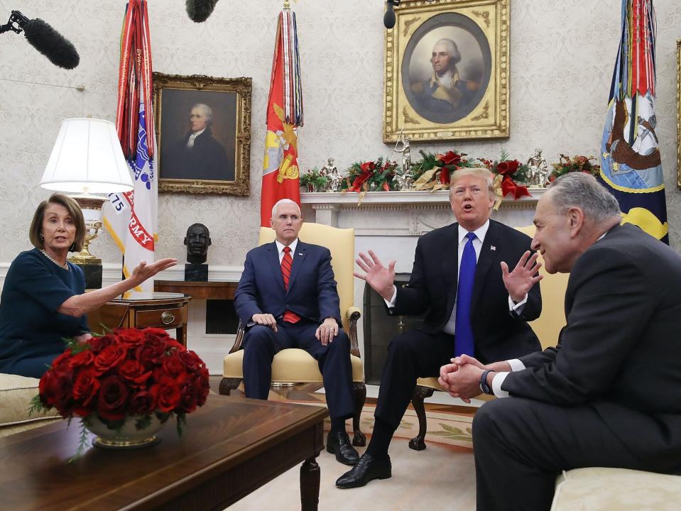 Then-President Donald Trump (2R) argues about border security with then-Senate Minority Leader Chuck Schumer, a Democrat of New York (R), and then-House Minority Leader Nancy Pelosi, a Democrat of California, as Vice President Mike Pence sits nearby in the Oval Office on December 11, 2018 in Washington, DC.