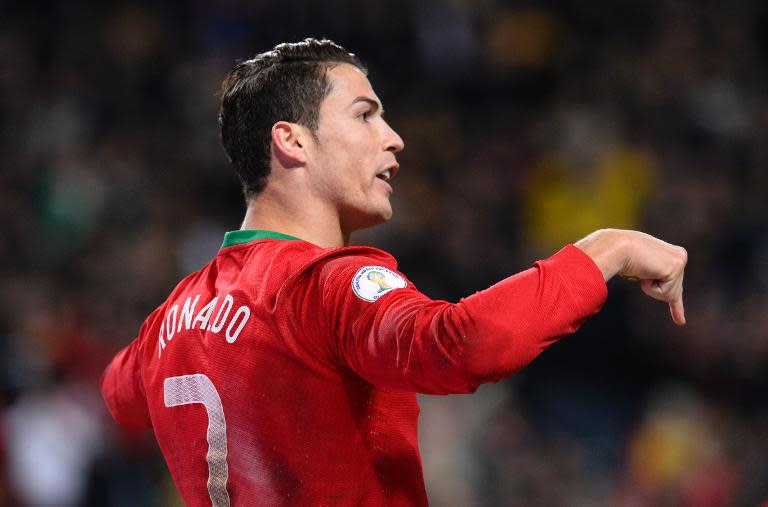 Portugal's forward Cristiano Ronaldo celebrates after scoring the second goal for Portugal during the 2014 World Cup playoff match against Portugal in Solna near Stockholm on November 19, 2013