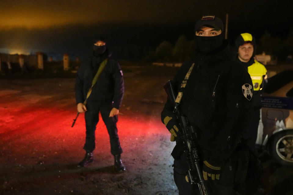 Russian servicemen guard a road towards a private jet crash, near the village of Kuzhenkino, Tver region, Russia, early Thursday, Aug. 24, 2023. Officials say a private jet has crashed over Russia, killing all 10 people on board. Mercenary chief Yevgeny Prigozhin was on the passenger list, and Russia’s civil aviation agency says he was on board. (AP Photo/Alexander Zemlianichenko)