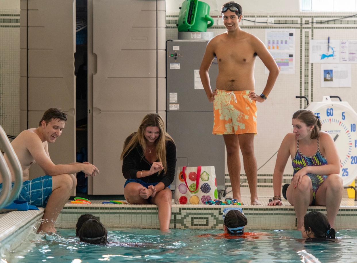 Swim instructors Tyler Long, Kendall Lavin-Parsons, Hari Sharma and Gretchen Weaver set up a game with teens in the water at the Central Community Branch YMCA Thursday.