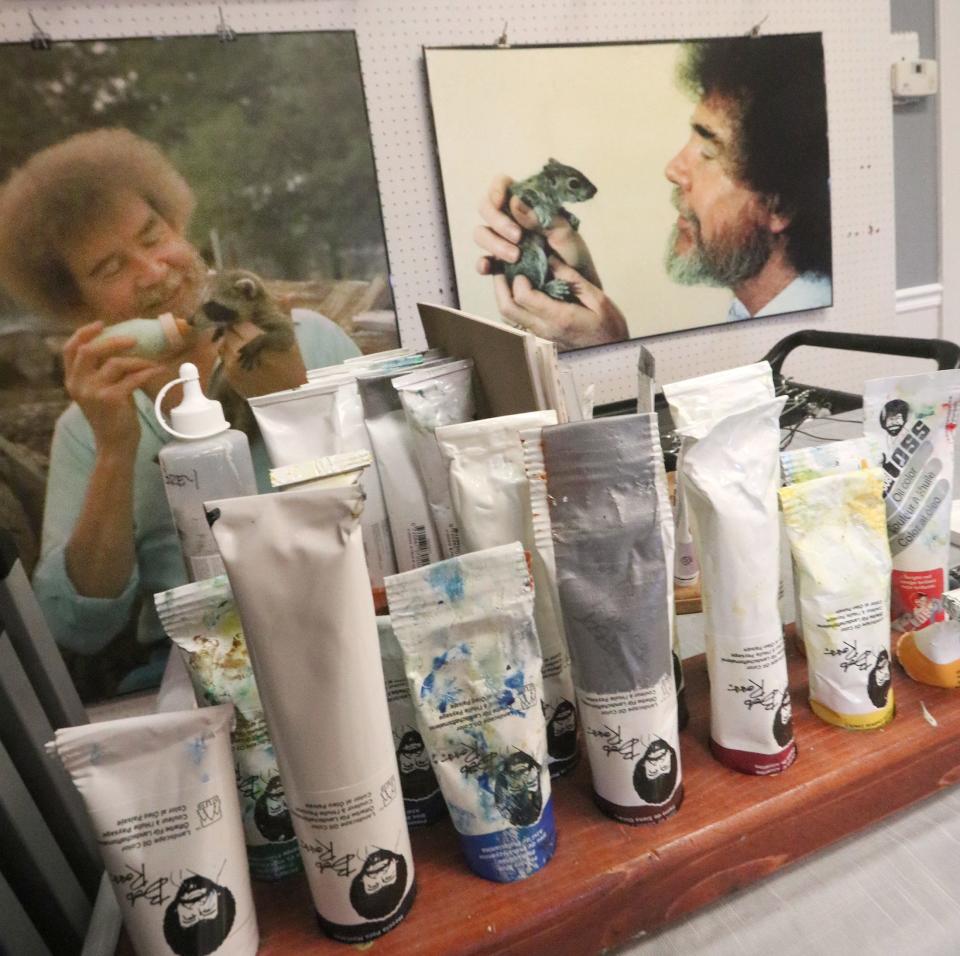 Portraits of Bob Ross and tubes of paint are seen in this 2020 file photo at the Bob Ross Art Workshop & Gallery in New Smyrna Beach.