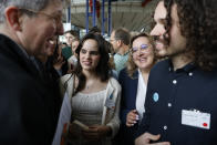 Portugal's Sofia Dos Santos Oliveira, center left, smiles after the European Court of Human Rights' ruling, Tuesday, April 9, 2024 in Strasbourg, eastern France. Europe's highest human rights court ruled that its member nations have an obligation to protect their citizens from the ill effects of climate change, but still threw out a high-profile case brought by six Portuguese youngsters aimed at forcing countries to reduce greenhouse gas emissions. (AP Photo/Jean-Francois Badias)