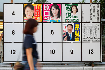 A woman walks past candidates' posters for the October 22 lower house election in Tokyo, Japan, October 10, 2017. REUTERS/Kim Kyung-Hoon