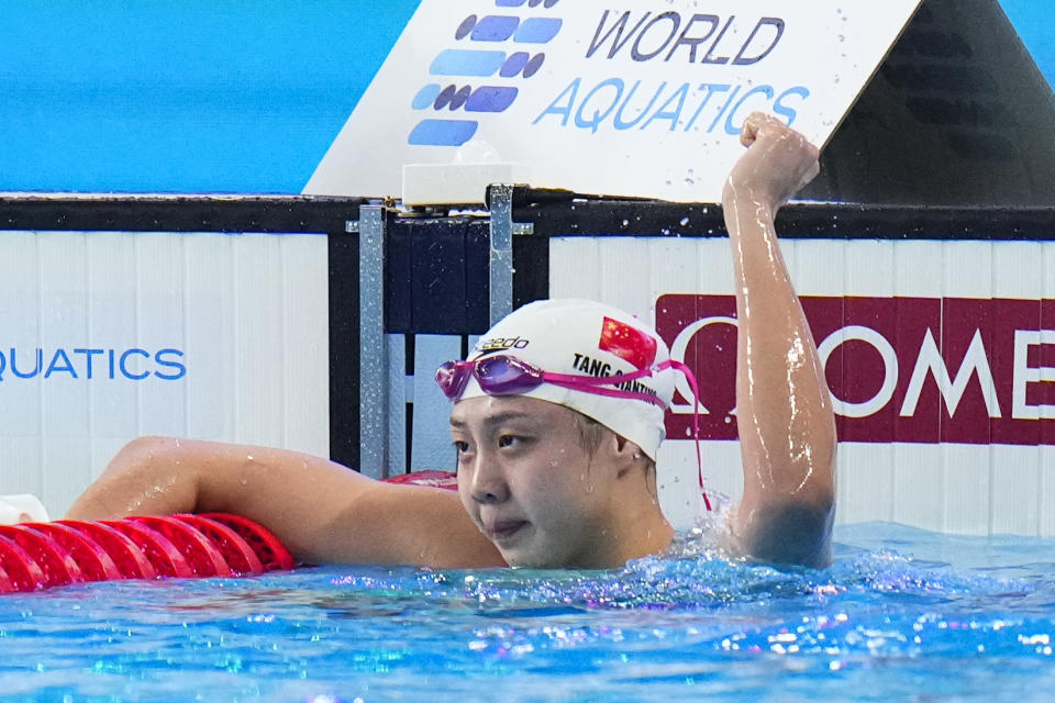 Tang Qianting of China celebrates after winning the gold medal in the women's 100-meter breaststroke final at the World Aquatics Championships in Doha, Qatar, Tuesday, Feb. 13, 2024. (AP Photo/Hassan Ammar)