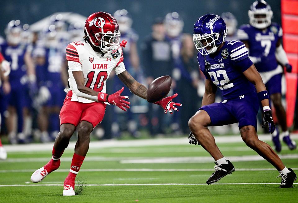 Utah Utes wide receiver Money Parks (10) reaches out to take the punt as Northwestern Wildcats defensive back Evan Smith (22) defends as Utah and Northwestern play in the SRS Distribution Las Vegas Bowl on Saturday, Dec. 23, 2023.