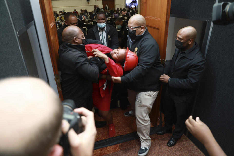 FILE - A member of the opposition, Economic Freedom Fighters (EFF) party is ejected from parliament in Cape Town, South Africa, Thursday, June 9, 2022 for disrupting proceedings. South African President Cyril Ramaphosa could face criminal charges and is already facing calls to step down over claims that he tried to cover up the theft of millions of dollars in U.S. currency that was hidden inside furniture at his game farm. (AP Photo/Nardus Engelbrecht, File)