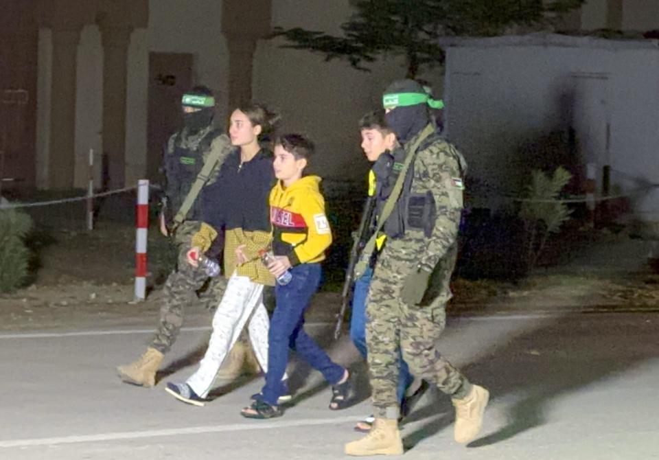 Hamas hands over some of the 11 Israeli hostages to the International Committee of the Red Cross in Gaza City, Gaza on November 27, 2023. <em>Photo by Stringer/Anadolu via Getty Images</em>