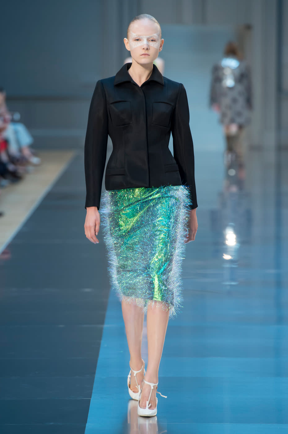 Among his many varied looks, Galliano showed this plastic tinsel skirt that was truly out of this world. He paired it with an architectural blazer that brought the look back down to earth.