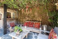 <p>Here’s the patio, which is surrounded by the lush landscaping. (Realtor.com) </p>