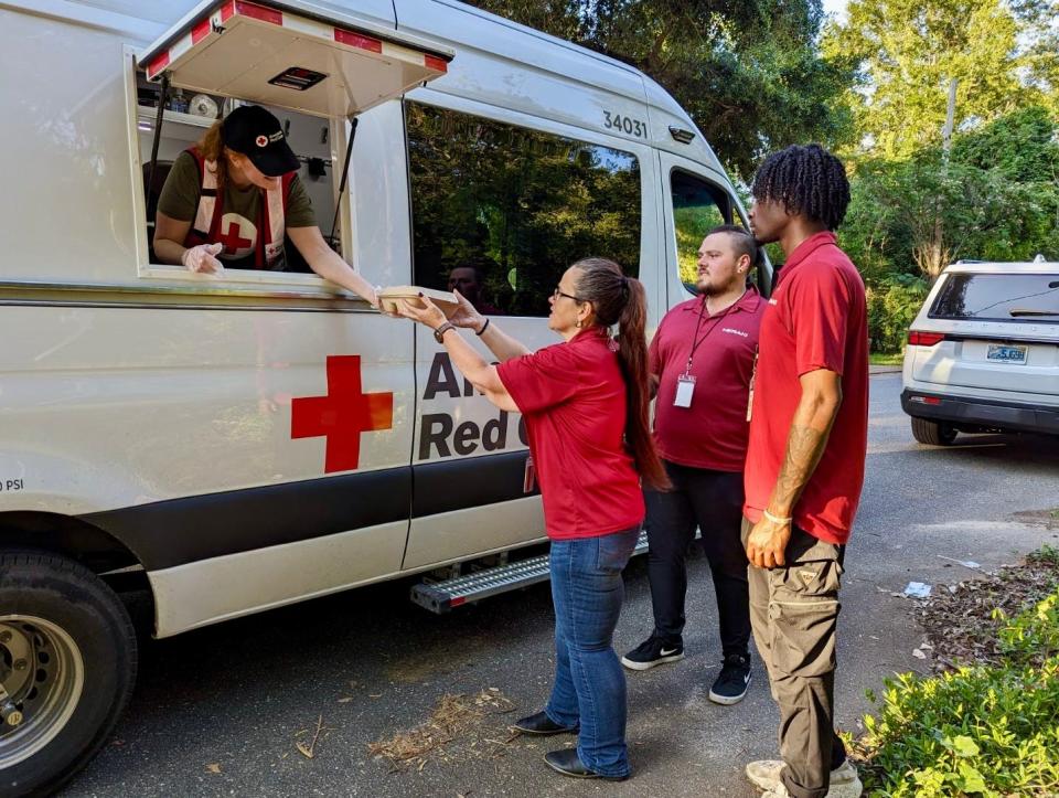 Kyndra Light, a board member and volunteer with the Capital City Chapter of the American Red Cross, passes out hot meals on May 19, 2024 following deadly tornadoes that tore parts of Tallahassee.