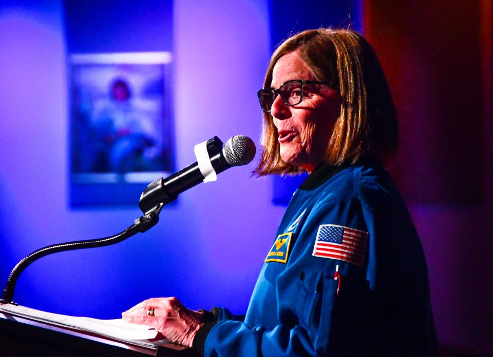 Former NASA shuttle astronaut Barbara Morgan delivers a keynote speech June 26 during the Space Port Area Conference for Educators sponsored by the Astronaut Memorial Foundation at the Kennedy Center Visitor Complex. Behind her is a framed portrait of Christa McAuliffe, who lost her life in the Challenger explosion.