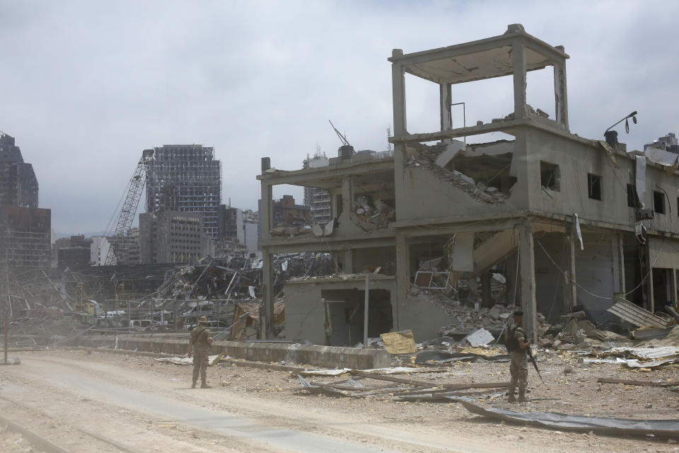 Soldier stand at the devastated site of the explosion at the port of Beirut, Lebanon, Thursday Aug.6, 2020. French President Emmanuel Macron has arrived in Beirut to offer French support to Lebanon after the deadly port blast.(AP Photo/Thibault Camus, Pool)