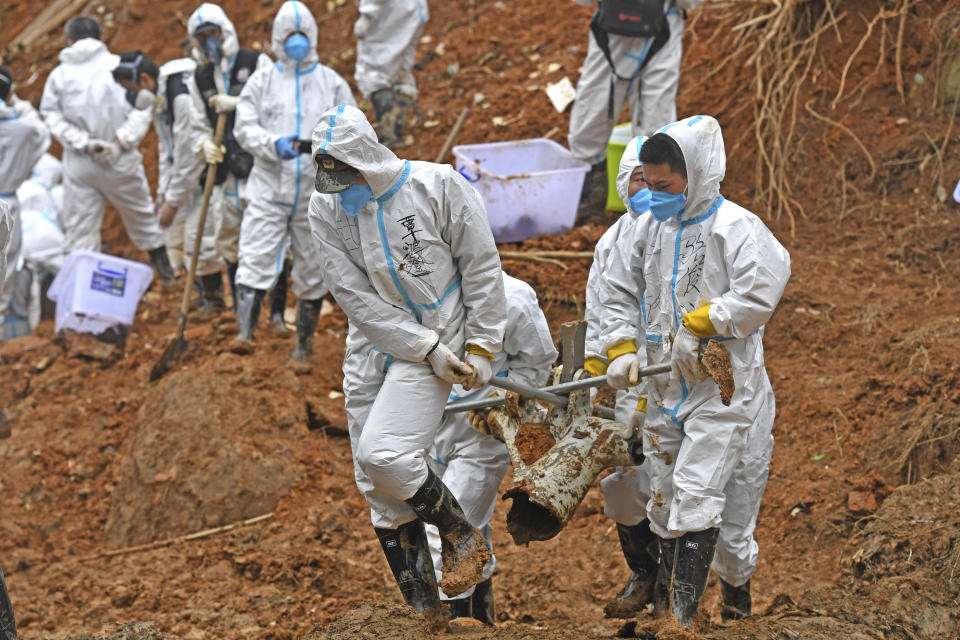 FILE - In this photo released by Xinhua News Agency, rescuers carry a piece of plane wreckage at the site of Monday's plane crash in Tengxian County, southern China's Guangxi Zhuang Autonomous Region, on March 25, 2022. The second “black box” has been recovered following the crash of a China Eastern Boeing 737-800 that killed 132 people last week, Chinese state media said Sunday, March 27. (Zhou Hua/Xinhua via AP, File)