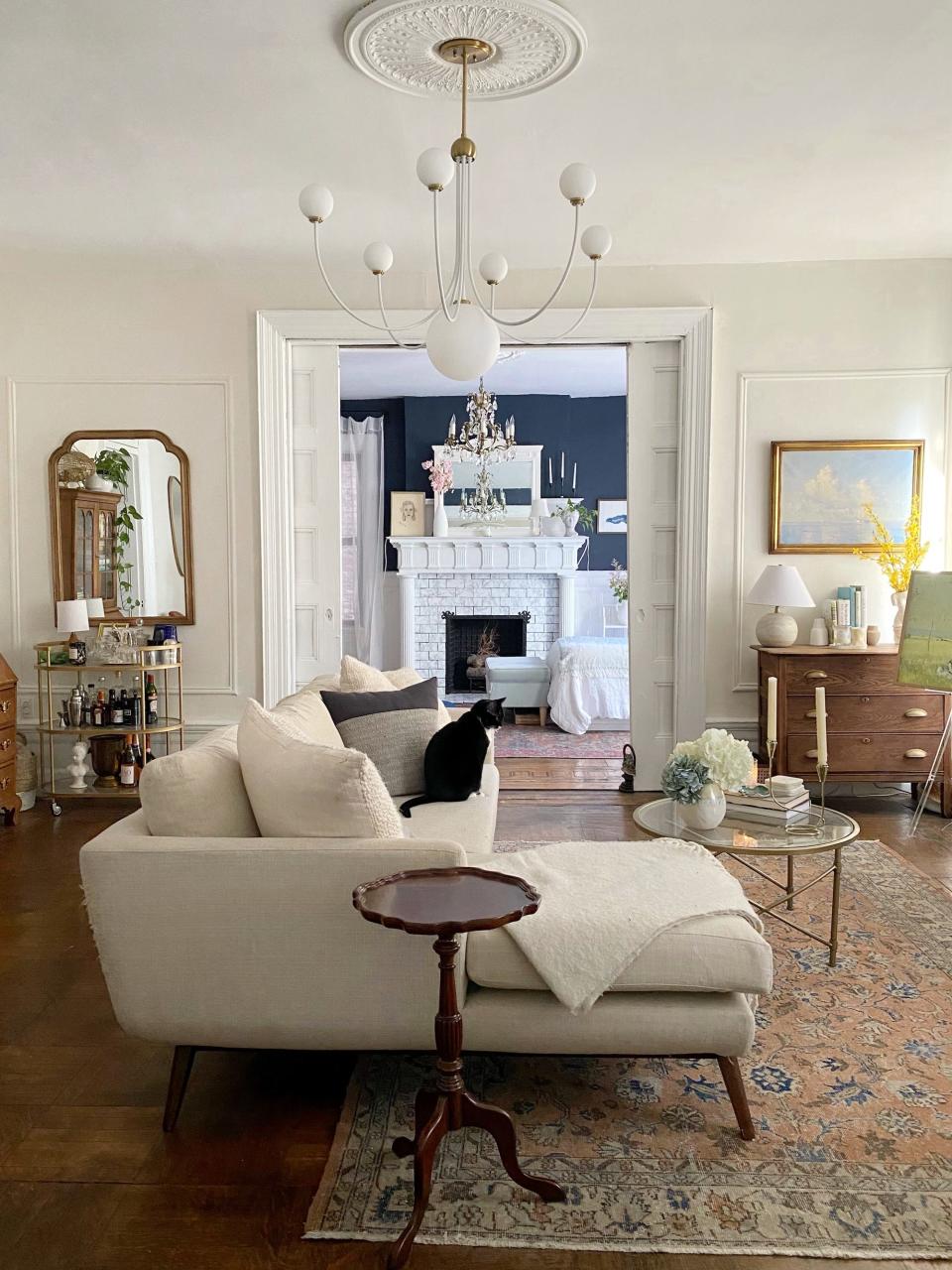 A living room with a white couch and an open door.