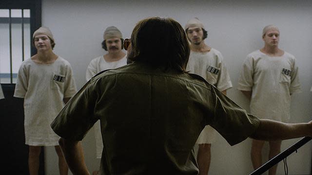 The Stanford Prison Experiment was a study conducted by Dr. Philip Zimbardo in the summer of 1971 at Stanford University. It was meant to show the psychology of imprisonment with 24 male undergraduates chosen to randomly participate either as a guard or a prisoner. What ensued was nothing short of groundbreaking and prompted both outrage and excitement from every corner of the scientific and psychological fields. <strong>REVIEW: Sundance Standout, Stanford Prison Experiment,' Is Intense, Almost Too Real</strong> To capture what happened on screen, Tim Talbott based his screenplay on Dr. Zimbardo’s documents, including audio and footage from the experiment. Meanwhile, director Kyle Patrick Alvarez is said to have let his actors -- a cast of up-and-coming talent -- take gross liberties on set in order to really dive in to their characters. On July 17, <em>The Stanford Prison Experiment</em> will debut in theaters, but not before ETonline wrangled stories from the cast about the physically grueling filming schedule, the power of costumes, going method, and bonding on set. <strong>Michael Angarano: “It Really Did Stop Me in My Tracks” </strong> IFC Films “Billy Crudup’s first day was really exciting for me,” says Angarano, a regular on Cinemax’s <em>The Knick</em>. “It was the scene where Dr. Zimbardo stops the experiment and I think they ended up using his very first take. It was supposed to stop us in our tracks [as the characters], but it really did stop me in my tracks. Just based on three lines he uttered, I was so impressed.” <strong>Nicholas Braun: “It Was a Mix of Pleasure and Discomfort” </strong> IFC Films “I'm friends, and have worked, with a lot of the guys playing prisoners,” says Braun, who also has roles in this year’s <em>Poltergeist</em> and <em>Jem and the Holograms</em>. “I play a guard in the film and I am quite physically abusive with the boys -- it was a mix of pleasure and discomfort having to get into it with them. My favorite day was shooting a scene where some of the guards make an extra aggressive entry into one of the cells to procure the prisoners cots as punishment for their misbehavior. Ezra [Miller] and I decided we'd pair up and go after each other, since our characters have a major confrontation in the film. All day long, he and I just fought. We were knocking into the walls and shaking the set. In between takes we kept it going, wrestling and keeping the adrenaline rushing. I think it brought something genuinely scary and violent to that scene.” <strong>Jesse Carere: “I Felt Demoralized” </strong> IFC Films “Dr. Zimbardo dressed the prisoners in gowns to make them feel demoralized,” says Carere, who made his mark on MTV’s <em>Skins</em>. “After wearing a gown for several weeks I felt demoralized. I wanted to be a guard by the end of the shoot and wear boots and wave a baton. I definitely carried a weight with the role. The chain around my ankle probably didn't help matters. When the shoot was over I felt like I could finally breathe again.” <strong>Keir Gilchrist: “I Became Close With the Guards”</strong> IFC Films “It never felt like we weren't shooting a movie,” says Gilchrist, often recognized for his role as Marshall Gregson on <em>United States of Tara</em> and appearing in the cult horror film, <em>It Follows</em>. “No one actually got locked up or abused or anything, but with that said, I did find myself being effected in a subtle way. I immediately became close with the guards on my shift. I walked with a bit more authority than the actors playing the prisoners. They spent all day barefoot in not much more than underwear, whereas I had a baton, a uniform and mirrored glasses. Wearing a uniform warps your perspective slightly.”   <strong>Miles Heizer: “I Talked About It With My Sister” </strong> IFC Films “Kyle put up a bunch of pictures from the actual experiment outside the set,” says Heizer, who played Drew Holt on <em>Parenthood</em> and will be in the upcoming thriller, <em>Nerve</em>, with Emma Roberts. “Even though we were having a great time, it was so interesting to stop and look at the pictures and realize this really happened. I talked about it with my sister, who’s a psychology major, before shooting, and we thought a lot about what the outcome would be if we had been part of that experiment. I’d like to think that I would not do anything, that I’d just tell people to calm down and that we could get through it because it was only an experiment. But that’s the entire point of it -- that’s what everyone thinks and the results were totally different.” <strong>Callan McAuliffe: “Everyone Was Jealous of My Ponytail” </strong> IFC Films “Everyone was jealous of my ponytail,” says the up-and-coming Aussie, who played the younger version of Jay Gatsby in Leonardo DiCaprio’s <em>The Great Gatsby</em> -- which says a lot in the looks department. “I had a bit of a smaller character role and because of that the audience wouldn’t be paying too much attention to me, so I got to have a ridiculous hairdo. I showboated around set all the time, always telling people how great my ponytail was. And, well, the other stuff that happened on set is probably too crazy to tell you.” <strong>Ezra Miller: “It Was an Amazing Experience” </strong> IFC Films “I didn’t have one bad day on the whole thing,” says the 22-year-old actor, who recently was appointed title role of Marvel’s big-screen adaptation of <em>The Flash</em>. “There wasn’t one experience where I felt the degradation of imprisonment. It was a great time with a bunch of cool homies. It was an amazing experience to be a part of an ensemble where everyone was always lifting each other up and raising each other’s game in this constant symbiotic process.” <strong>Logan Miller: “It Would at Times Feel Very Real”</strong> IFC Films “Some of the toughest days were dealing with the routine exercises and knowing that they would get more and more sinister as the shoot days went on,” says Miller, a former Disney star on <em>I’m in the Band</em>, who looked forward to focusing on more dark, comedic, adult-centric content. “When we were filming the coverage for the observation camera used in the film, it would at times feel very real. We would play out the scenes all the way through, with the set completely intact and no other equipment around. Playing those through in the setting made it feel sometimes that the film could maybe even become the experiment itself.” <strong>Tye Sheridan: “The Environment Felt Very Real”</strong> IFC Films “At times the environment felt very real,” says Sheridan, whose quick rise to fame came with an outstanding performance in <em>Mud</em> alongside Matthew McConaughey. “Dimensionally, the stage that we worked on was an exact replica of the hallways and classrooms at Stanford University where the actual experiment took place. The film is highly intense and raw. I hope that an audience member would get lost in the film and begin to feel the pain and confusion that these young men endured. The film has been thirteen years in the making, so I just feel honored to have been around at the right place and time to be cast in the film.” <strong>Johnny Simmons: “It Terrified Me”</strong> IFC Films “I read <em>The Lucifer Effect</em> [Dr. Zimbardo’s book about the experiment] several years ago while shooting <em>Scott Pilgrim vs. the World</em>,” says Simmons, a prolific young actor with leads in such films as <em>The Perks of Being a Wallflower</em> and <em>The To Do List</em>. “I would highly suggest it as a companion to the film as it reveals the universal laws of human nature which most of us would choose to ignore. It terrified me. Never in a million years did I think I would be part of the movie version, and it is truly a dream come true to be sharing this story with the rest of the world.”