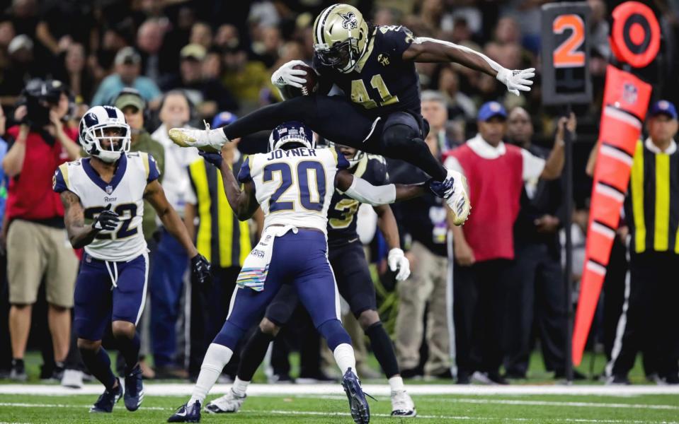 New Orleans Saints running back Alvin Kamara hurdles Rams safety Lamarcus Joyner in his team's 45-35 win on Sunday - USA TODAY Sports