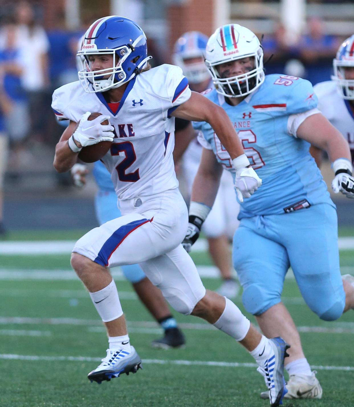 Lake football's Nate Baker (2) picks up yardage against Alliance at Kehres Stadium on Friday, August 19, 2022.