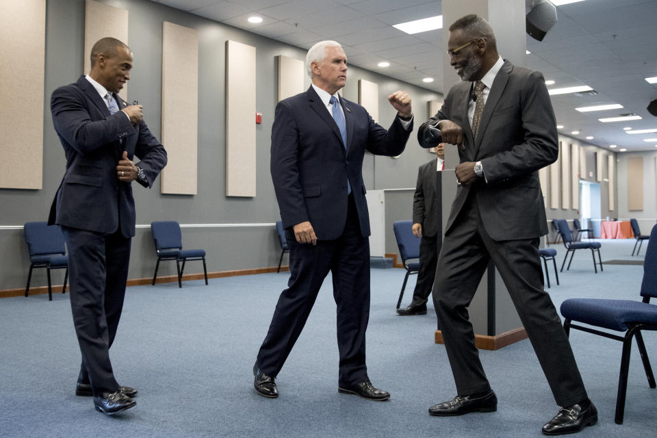 Vice President Mike Pence, center, accompanied by Scott Turner, Executive Director of the White House Opportunity and Revitalization Council, left, greets Bishop Harry Jackson as he meets with community and faith leaders at Hope Christian Church, Friday, June 5, 2020, in Beltsville, Md. (AP Photo/Andrew Harnik)