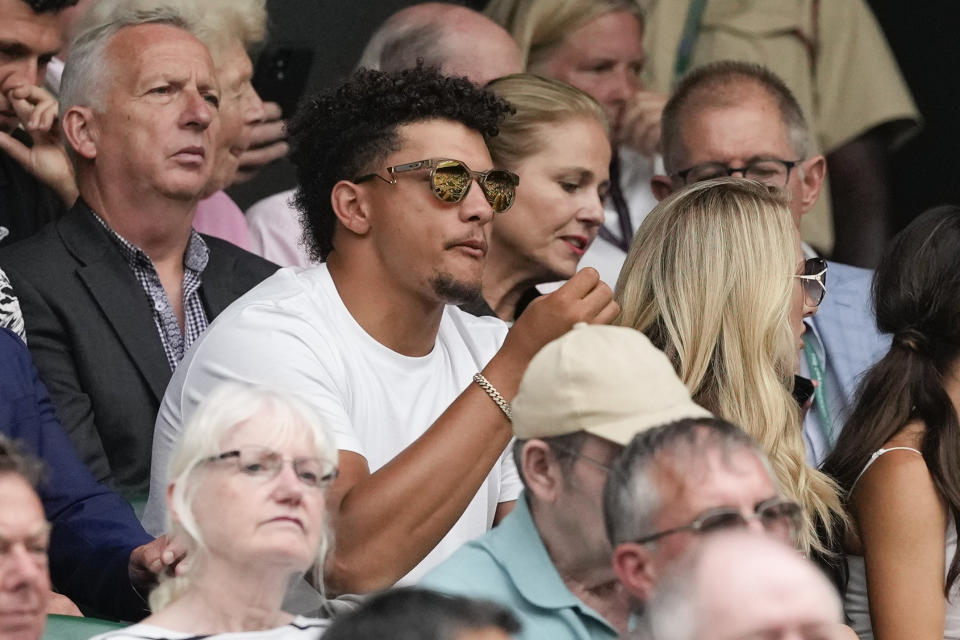 Patrick Mahomes and his wife Brittany, right, watch the third round match between Spain's Carlos Alcaraz and Francis Tiafoe of the United States on Centre Court at the Wimbledon tennis championships in London, Friday, July 5, 2024. (AP Photo/Alberto Pezzali)