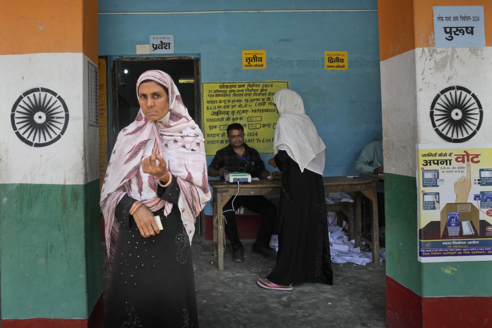 A Muslim woman displays the indelible ink mark on her index finger after casting her vote on the outskirts of Samastipur, in the eastern Indian state of Bihar, Monday, May 13, 2024. (AP Photo/Manish Swarup)