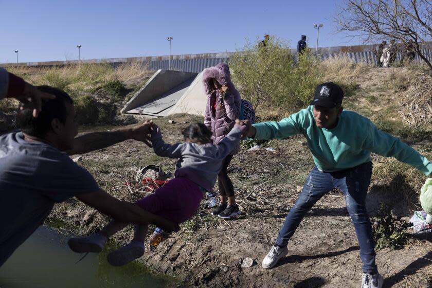 Migrants cross the Rio Bravo at the US and Mexico border in Ciudad Juarez, Mexico, on Wednesday, March 29, 2023. A fire at an immigration detention center in Ciudad Juarez in Northern Mexico was due to a protest by the migrants themselves when they were going to deported or mobilized, Mexicos President Andres Manuel Lopez Obrador said in a press briefing Tuesday. Photographer: Nicolo Filippo Rosso/Bloomberg via Getty Images