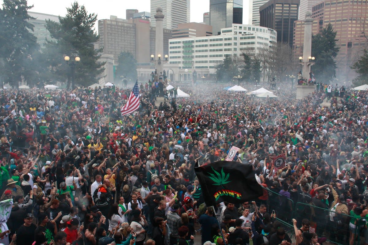 Members of a crowd numbering tens of thousands smoke marijuana and listen to live music at the Denver 420 pro-marijuana rally at Civic Center Park in Denver on 20 April 2013 (Copyright 2024 The Associated Press. All rights reserved.)