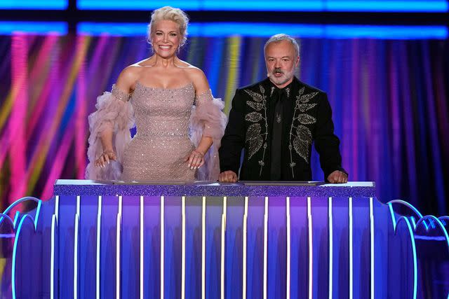 <p>Martin Meissner/AP</p> Presenters Hannah Waddingham, left, and Graham Norton during the Grand Final of the Eurovision Song Contest