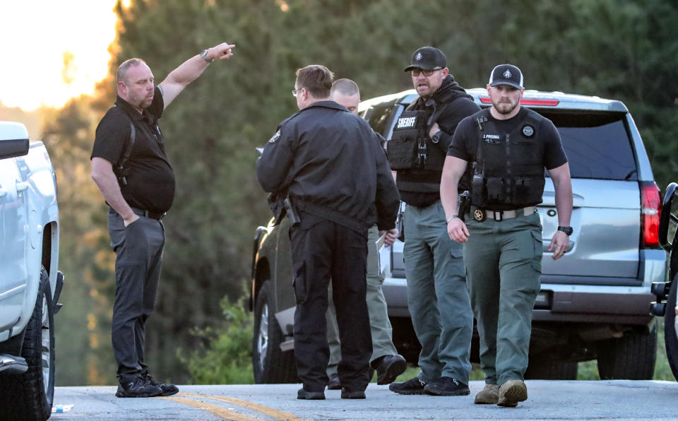 Law enforcement work the scene scene following a police chase Monday, April 12, 2021, in Carroll County, Ga. Georgia authorities say multiple officers were injured when the passenger of a car shot them during a police chase that ended with one suspect killed and the other arrested. (John Spink/Atlanta Journal-Constitution via AP)