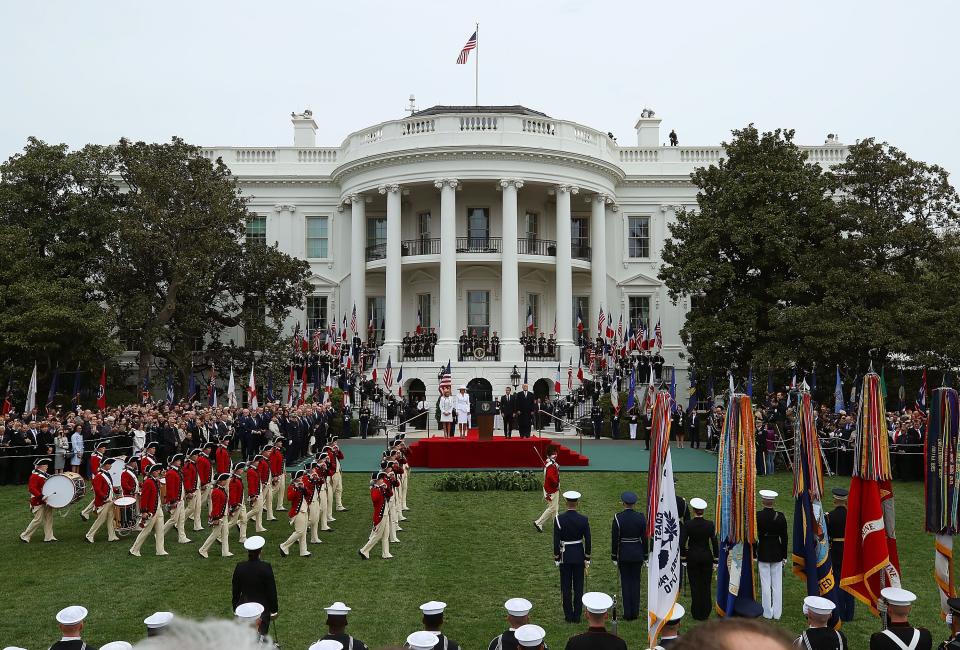 President Donald Trump and first lady Melania Trump welcome French President Emmanuel Macron and French first lady Brigitte Macron during an arrival ceremony at the White House on April 24, 2018.