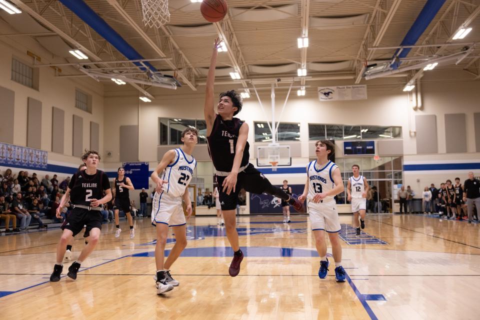 Texline’s Elias Espino (1) flying towards the basket during a district game Tuesday January 11th, Texline at Wildorado in Wildorado, TX. Trevor Fleeman/For Amarillo Globe-News.