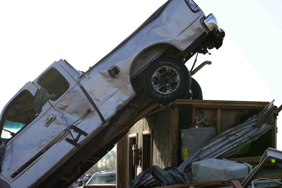 Wind-tossed vehicles, are piled onto another in Rolling Fork, Miss., Saturday, March 25, 2023, the day after a series of storms produced tornadoes moved through the area. Emergency officials in Mississippi say several people have been killed by tornadoes that tore through the state on Friday night, destroying buildings and knocking out power as severe weather produced hail the size of golf balls moved through several southern states. (AP Photo/Rogelio V. Solis)