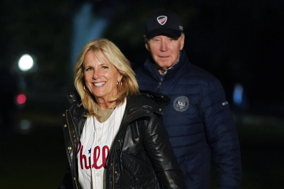 FILE - First lady Jill Biden wears a Philadelphia Phillies jersey as she and President Joe Biden walk on the South Lawn of the White House after stepping off Marine One, Oct. 23, 2022, in Washington. (AP Photo/Patrick Semansky, File)