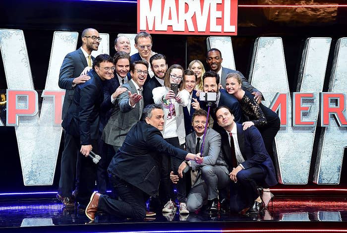 Cast members pose with competition winner Lottie French (C) for a selfie during the European Premiere of "Captain America: Civil War"