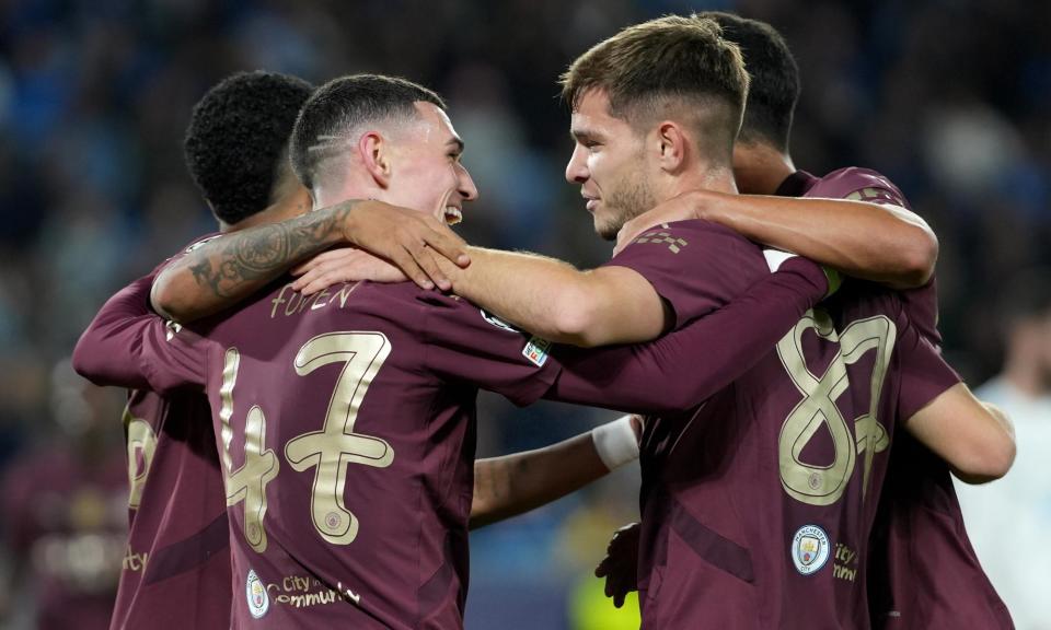 <span>James McAtee (right) of Manchester City celebrates scoring his first goal for the club, the fourth in a regulation win against Slovan Bratislava.</span><span>Photograph: Jakub Gavlák/EPA</span>