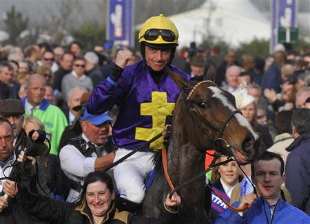 Jockey Davy Russell riding Lord Windermere celebrates winning the Gold Cup at the Cheltenham Festival horse racing meet in Gloucestershire, western England March 14, 2014. REUTERS/Toby Melville