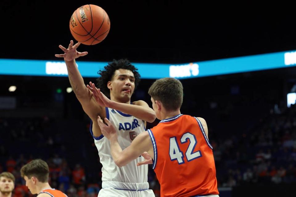 Isaiah Cochran, who led Adair County with 16 points and nine rebounds, whipped a pass around Marshall County’s Matthew Langhi (42) during Wednesday night’s win in Rupp Arena.