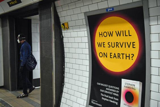 A poster promoting a book by Stephen Hawking on a passageway in London's Oxford Street Underground station the day after Prime Minister Boris Johnson put the UK in lockdown to help curb the spread of the coronavirus. (Kirsty O&#039;Connor/PA Wire/PA Images)