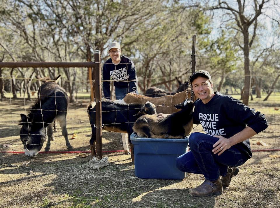 Winding Branch Ranch co-founders Matthew Aversa, back left, and his husband, Tim Kessler, tend to animals on their property in Bulverde, Texas on Dec. 6, 2023. Gifting a pet as a surprise at the holidays is widely not recommended. (Morgan Arbo via AP)