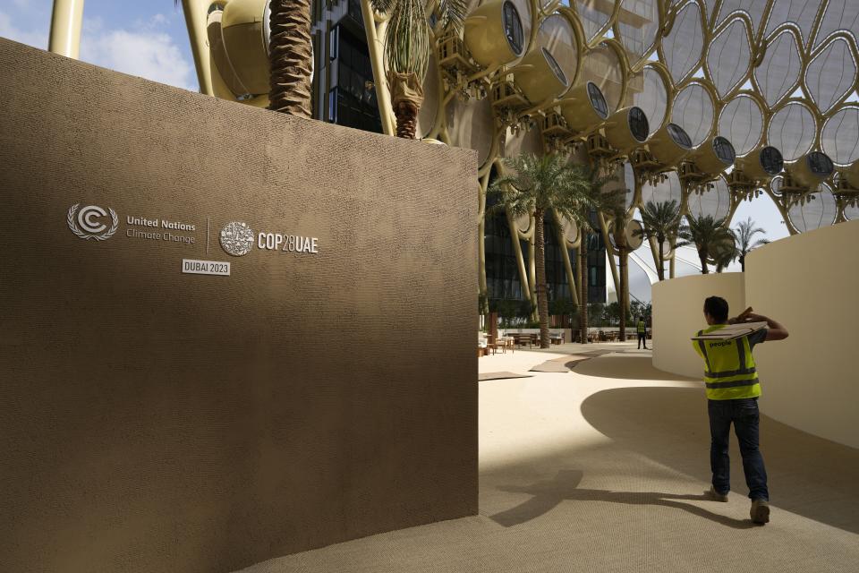 FILE - A worker sets up ahead of the COP28 U.N. Climate Summit, Wednesday, Nov. 29, 2023, in Dubai, United Arab Emirates. (AP Photo/Peter Dejong, File)