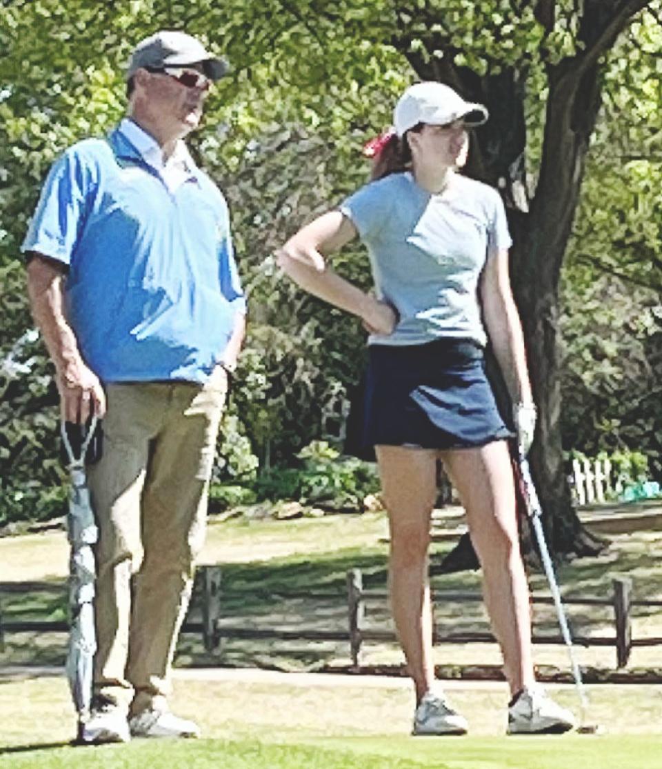 Bartlesville high School assistant girls golf coach Terry Hughes and Lady Bruin one-bag standout Lisa Brown watch tourney action during the 2022 season.