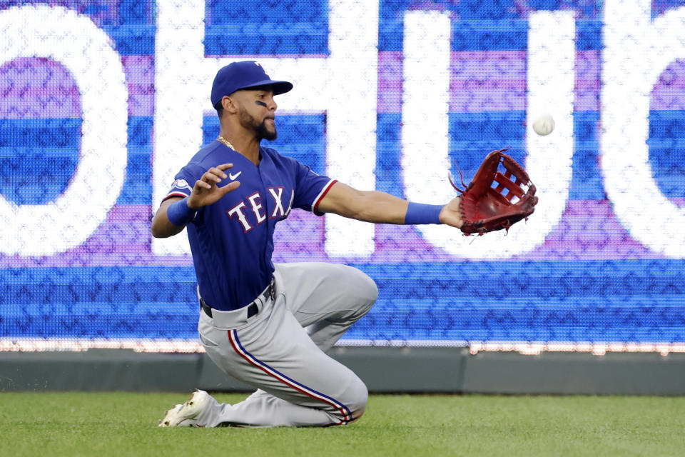 Texas Rangers center fielder Leody Taveras is unable to catch a hit by Kansas City Royals' Whit Merrifield during the second inning of a baseball game in Kansas City, Mo., Monday, June 27, 2022. Merrifield doubled, scoring two runs on the play. (AP Photo/Colin E. Braley)