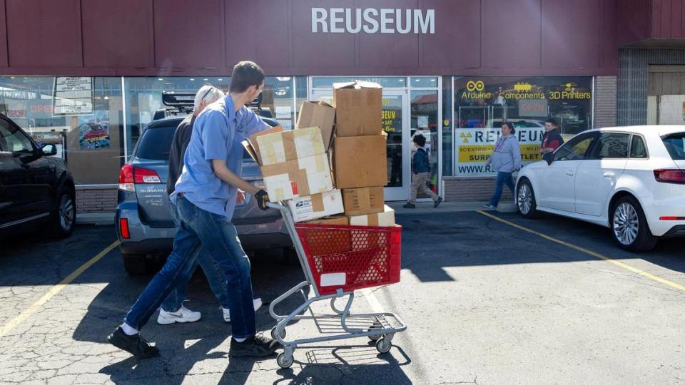 Reuseum employee Trevor Felgenhauer pushes a cart of donated items from a customer. The Reuseum refurbishes and resells electronics when it can -- and helps to recycle component parts when items are beyond repair.