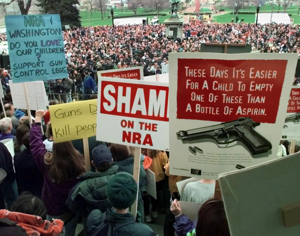 FILE - In this May 1, 1999, file photo, demonstrators gather on the Colorado State Capitol grounds in Denver, Colo., to protest against the National Rifle Association's annual meeting, which is being held in the city. The convention was planned long before the recent shootings at nearby Columbine High School, and the association has scaled the event down in the wake of the tragedy. (AP Photo/Eric Gay, File)