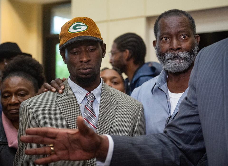 'Goon Squad' victim Michael Jenkins and his father Melvin Jenkins listen to lawyer Malik Shabazz during a press conference after the sentencing at the Rankin County Circuit Court in Brandon on Wednesday.