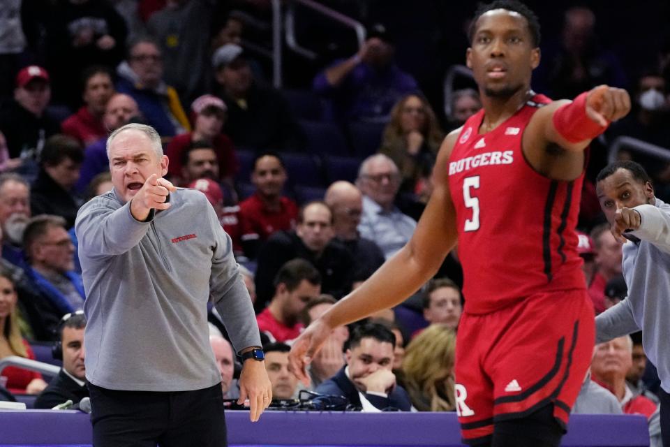 Rutgers head coach Steve Pikiell, left, points as he calls players during the first half of an NCAA college basketball game against Northwestern in Evanston, Ill., Wednesday, Jan. 11, 2023.